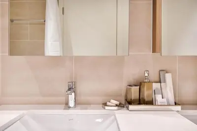 a bathroom with a sink and a mirror at Modern 2BR Apartment at Grove 5 - Creek Beach & Pool Access in Dubai