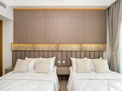 two beds sitting next to each other in a bedroom at Stunning 2BR at Azizi Amber Sleeps 5 in Dubai