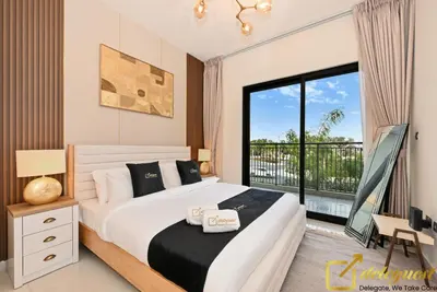 a bedroom with a large bed and a large window at Signature 3BR Maid Villa DH2 by Deleguest in Dubai