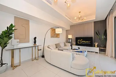 a living room with a couch and a table at Signature 3BR Maid Villa DH2 by Deleguest in Dubai