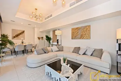 a living room with a couch and a table at Signature 3BR Maid Villa DH2 by Deleguest in Dubai