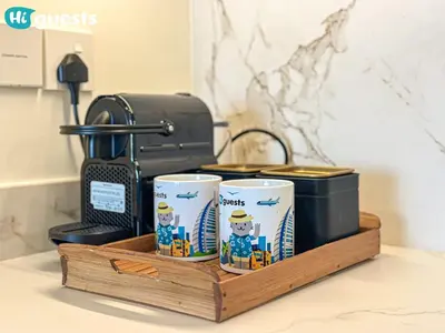 a wooden tray with three coffee cups on a counter at HiGuests - Sunlit 1 BR Escape with Emaar Beachfront Access in Dubai