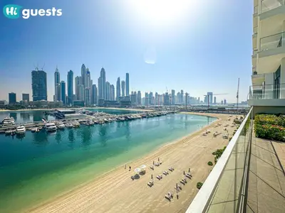 a view of a beach with a city in the background at HiGuests - Sunlit 1 BR Escape with Emaar Beachfront Access in Dubai