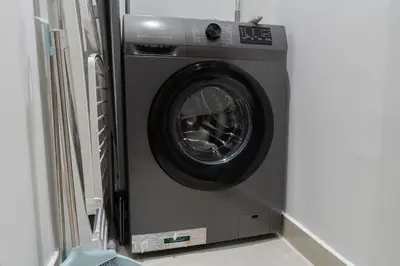 a washing machine is in a corner of a room at Boutique 1BHK at Nobles Tower By Czechin in Dubai