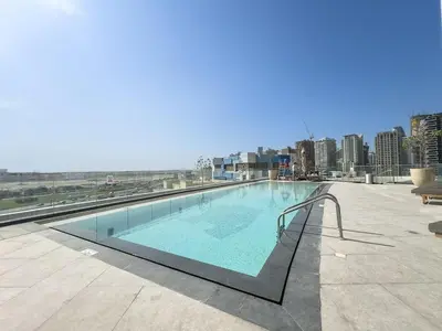 a swimming pool on the roof of a building at Boutique 1BHK at Nobles Tower By Czechin in Dubai
