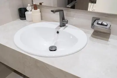 a white sink with a faucet in a bathroom at Boutique 1BHK at Nobles Tower By Czechin in Dubai