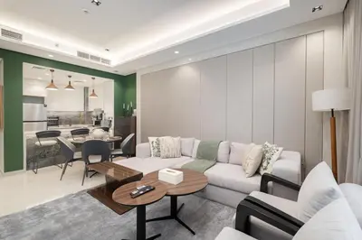 a living room with a couch and a table at Boutique 1BHK at Nobles Tower By Czechin in Dubai
