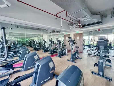 a gym with rows of exercise bikes and treadmills at Classy Studio ideal for long stays with balcony in Dubai