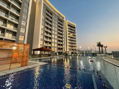 a large swimming pool in front of a building at Studio in Liwan for long stays 1005 in Dubai