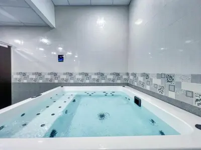 a large bath tub filled with water in a room at Studio in Liwan for long stays 1005 in Dubai