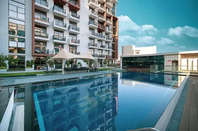 a large swimming pool in front of a building at New studio in Arjan ideal for long stays in Dubai