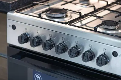 a stove top oven with pots and pans on it at New studio in Arjan ideal for long stays in Dubai