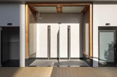 an entrance to a building with two glass doors at New studio in Arjan ideal for long stays in Dubai