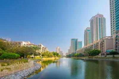 a river in the middle of a city with tall buildings at Serene Studio at The Links Canal in Dubai