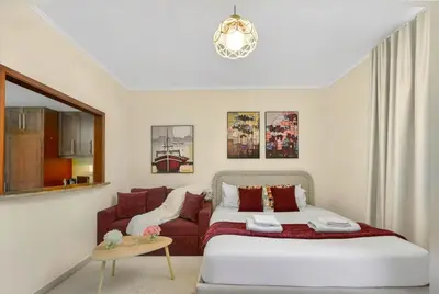 a bedroom with a bed and a couch at Serene Studio at The Links Canal in Dubai