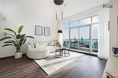 a living room with a white couch and a large window at 77 Floor Luxury 1Br Marina Sea View Balcony in Dubai