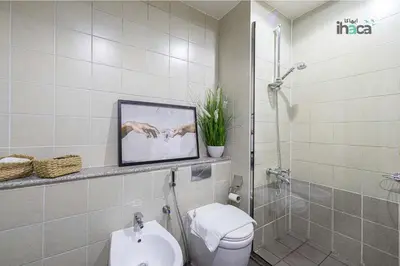 a bathroom with a shower and a toilet and a sink at 77 Floor Luxury 1Br Marina Sea View Balcony in Dubai