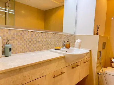 a bathroom with a sink and a mirror at Downtown Luxury 1BR with Pool, Gym, Fast WiFi and 8 Min Walk to Burj Khalifa in Dubai