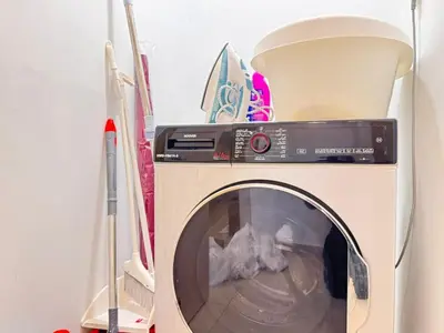 a washing machine with its door open in a room at Downtown Luxury 1BR with Pool, Gym, Fast WiFi and 8 Min Walk to Burj Khalifa in Dubai