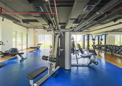 a gym with lots of treadmills and machines at Downtown Luxury 1BR with Pool, Gym, Fast WiFi and 8 Min Walk to Burj Khalifa in Dubai