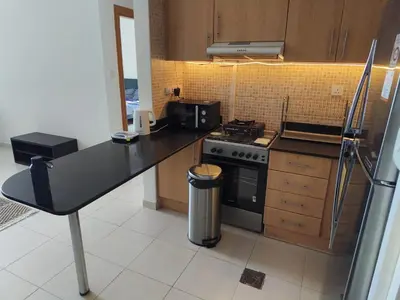 a kitchen with a counter top and a stove at Large 1-bedroom by the canal, close to downtown in Dubai