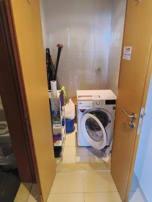 a laundry room with a washing machine in it at Large 1-bedroom by the canal, close to downtown in Dubai