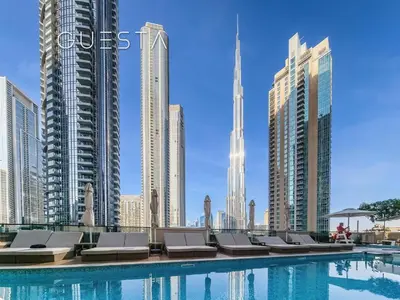a pool in a city with tall buildings at Burj khalifa in Dubai