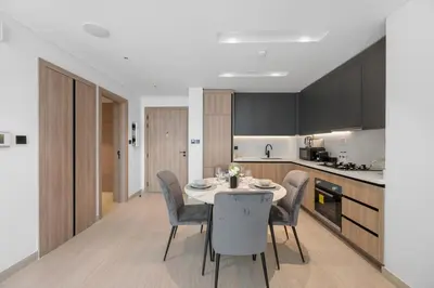 a kitchen and dining room with a table and chairs at Modern Apartment w/ Balcony & Rooftop Amenities in Dubai