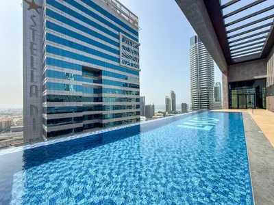 a large swimming pool on the roof of a building at Modern Apartment w/ Balcony & Rooftop Amenities in Dubai