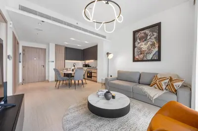 a living room with a couch and a table at Modern Apartment w/ Balcony & Rooftop Amenities in Dubai