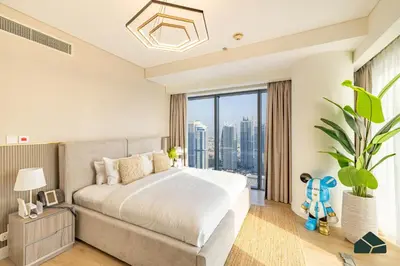 a bedroom with a large bed and a large window at Upgraded 1BR in JW Marriot with Marina View by BMS in Dubai