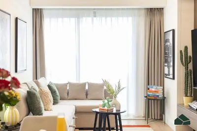a living room with a couch and a large window at Upgraded 1BR in JW Marriot with Marina View by BMS in Dubai
