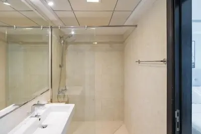a bathroom with a shower and a sink at Urban Haven - Peaceful Sanctuary - City Loft in Dubai