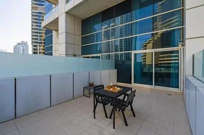 a balcony with a table and chairs on a building at Urban Haven - Peaceful Sanctuary - City Loft in Dubai