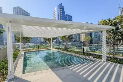 a white canopy over a swimming pool on a building at Stylish 2 Bedroom with Panoramic canal View in Dubai
