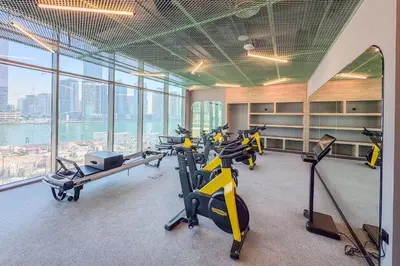 a gym with a bunch of exercise bikes in a building at Stylish 2 Bedroom with Panoramic canal View in Dubai