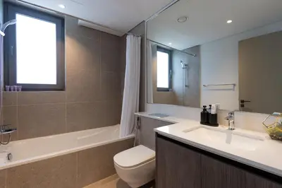 a bathroom with a sink and a toilet and a tub at Spacious 3BR Villa plus Maids with Resort-Style Amenities in Tilal Al Ghaf in Dubai