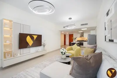 a living room with a couch and a tv at Vogue DIFC Damac Park Tower near Museum of The Future, One Bedroom Apartment with Balcony, City Skyline and Museum of The Future View, Access to all Amenities in Dubai
