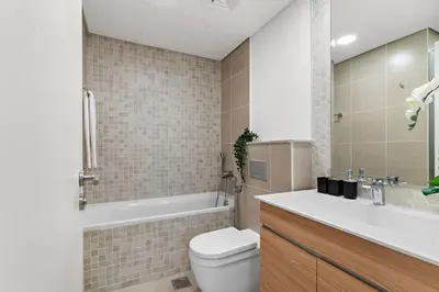 a bathroom with a toilet and a tub and a sink at The Smart Concierge - Andalus Jumeirah Golf Estates in Dubai