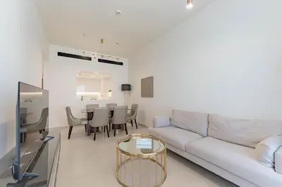 a living room with a white couch and a table at HAVN - 3 bedroom in Binghatti Crest, JVC in Dubai