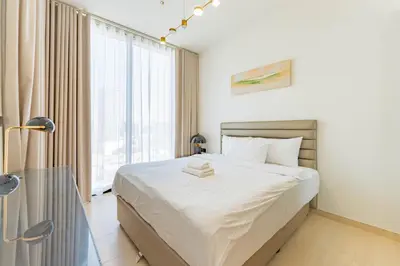 a bedroom with a bed and a large window at HAVN - 3 bedroom in Binghatti Crest, JVC in Dubai