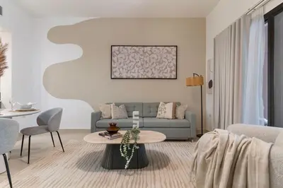 a living room with a couch and a table at The Smart Concierge - Andalus Jumeirah Golf Estates in Dubai