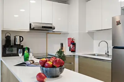 a kitchen with a bowl of apples on a counter at The Smart Concierge - Andalus Jumeirah Golf Estates in Dubai