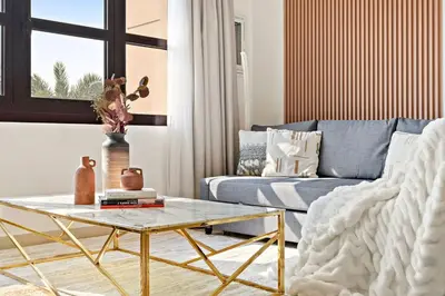 a living room with a couch and a coffee table at The Smart Concierge - Andalus Jumeirah Golf Estates in Dubai