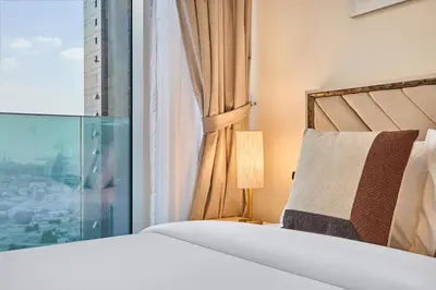 a bedroom with a bed and a window at Modern 2BR Apartment with Zabeel Park & Skyline Views in Dubai