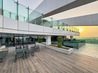 a lobby of a building with benches and tables at Modern 2BR Apartment with Zabeel Park & Skyline Views in Dubai