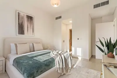 a white bedroom with a large bed in it at The Smart Concierge - Andalus Jumeirah Golf Estates in Dubai