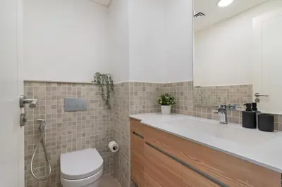 a bathroom with a sink and a toilet at The Smart Concierge - Andalus Jumeirah Golf Estates in Dubai