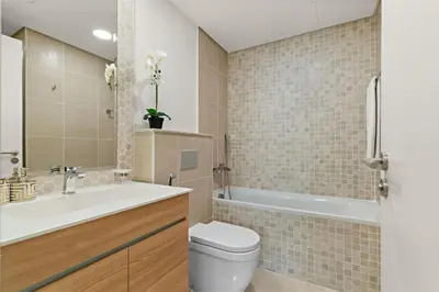 a bathroom with a tub and a toilet and a sink at The Smart Concierge - Andalus Jumeirah Golf Estates in Dubai
