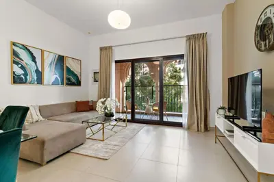 a living room with a couch and a television at The Smart Concierge - Andalus Jumeirah Golf Estates in Dubai